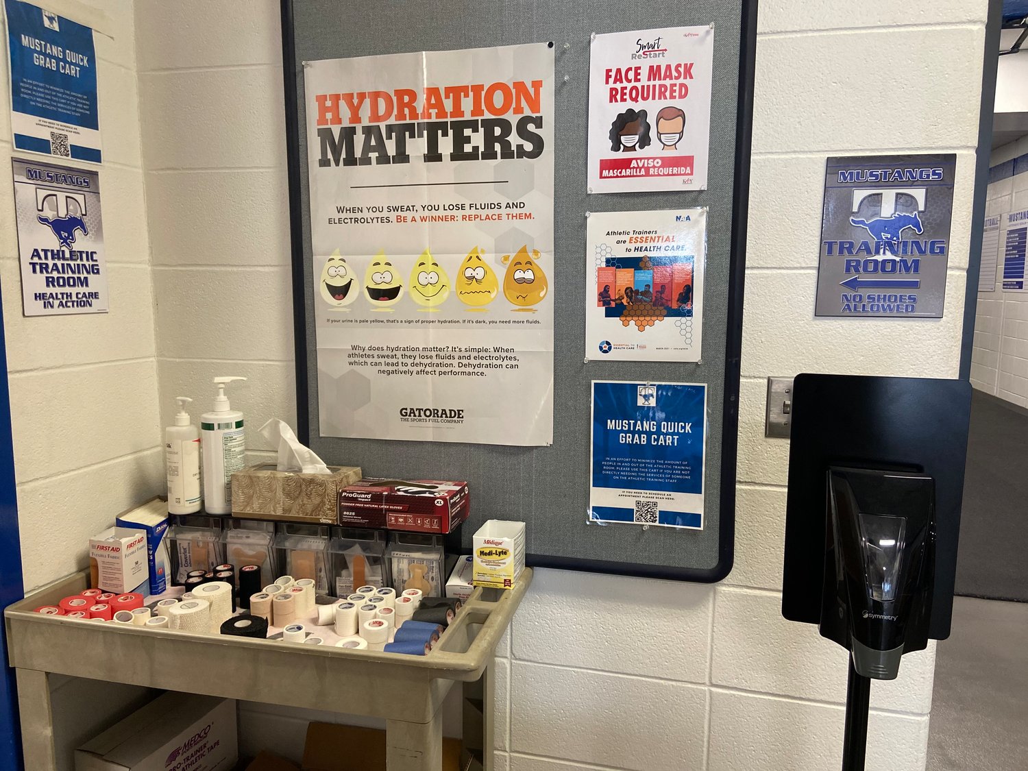 Pictured is the Mustang “Quick Grab” cart with essentials located outside of the athletic training room in order to limit foot traffic inside it.
